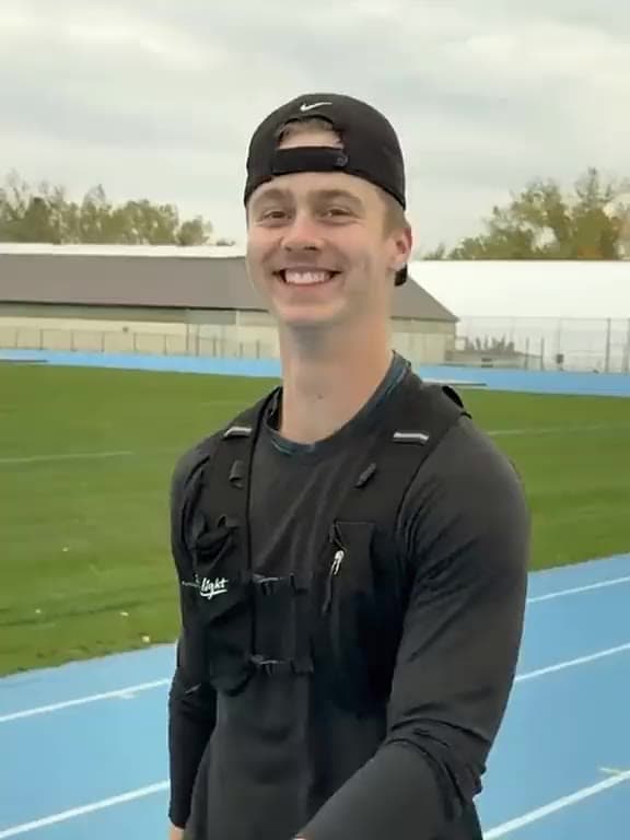 Benjamin Picard, personal trainer and founder of Picard Performance, smiling on a running track